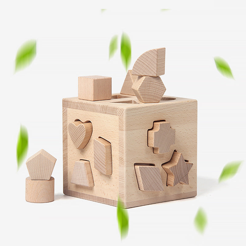 18-month-old child safely touching unfinished beechwood shape sorter with smooth edges, experiencing natural sensory play