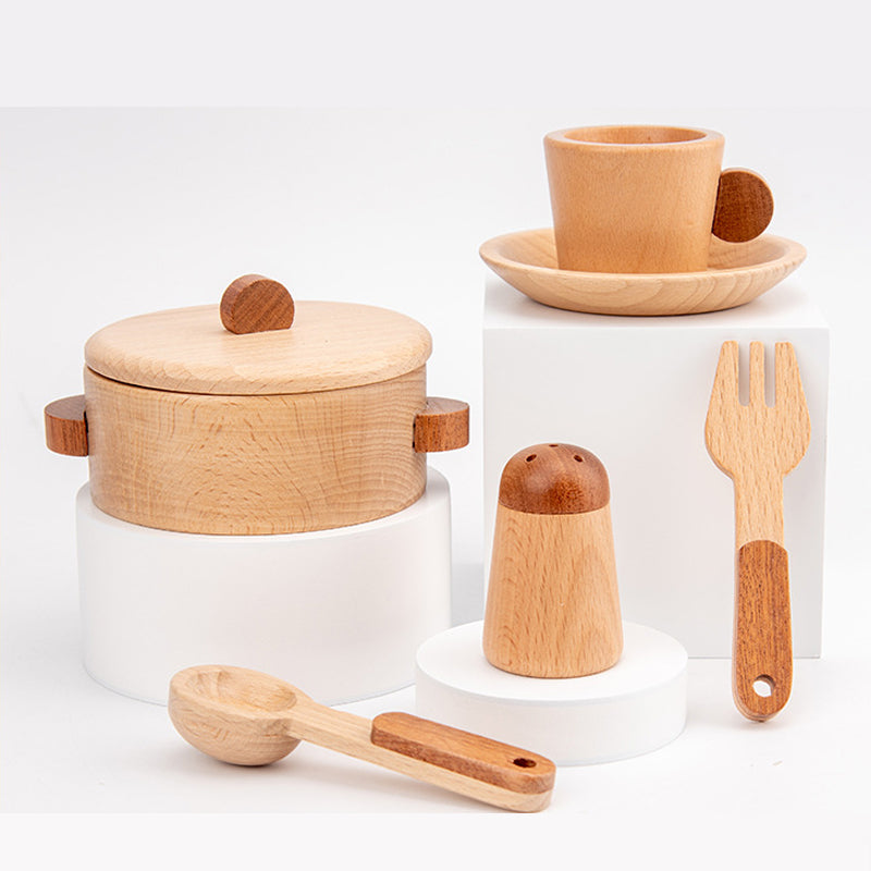 Child playing with realistic wooden kitchen toy, engaging in role play