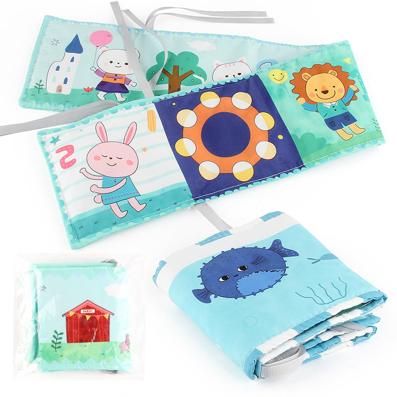 Newborn baby looking at a double-sided contrast book attached to the crib for visual development