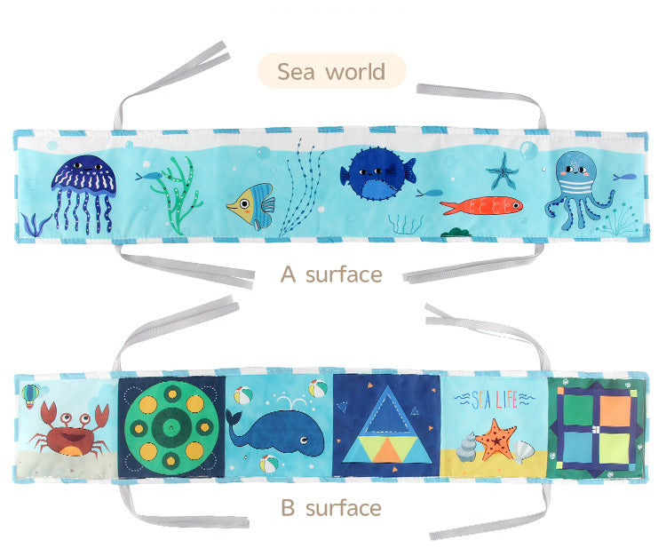 Newborn baby looking at a double-sided contrast book attached to the crib for visual development
