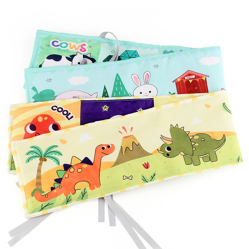 Newborn baby looking at a double-sided contrast book attached to the crib for visual development