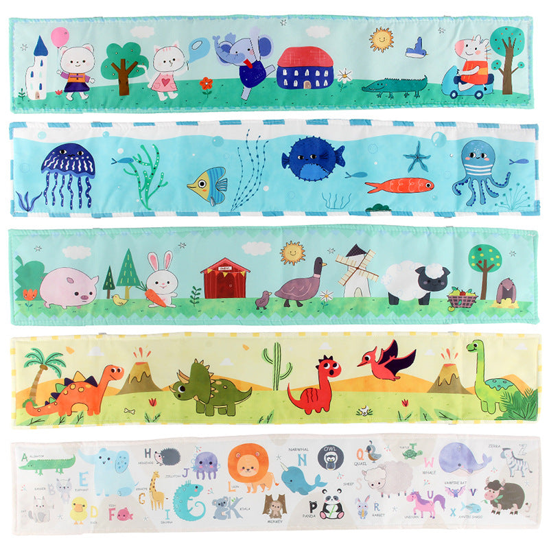 Newborn baby looking at a double-sided contrast book attached to the crib for visual development