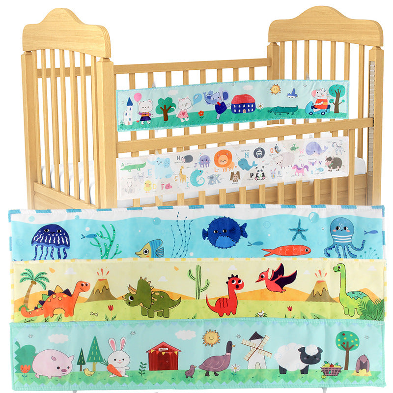 Newborn baby looking at a double-sided contrast book attached to the crib for visual development