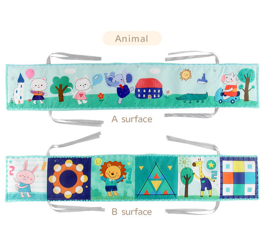 Newborn baby looking at a double-sided contrast book attached to the crib for visual development