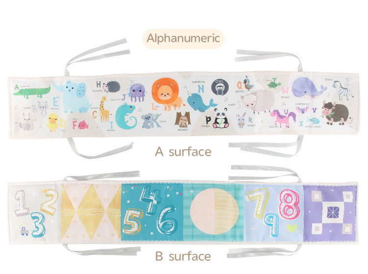 Newborn baby looking at a double-sided contrast book attached to the crib for visual development