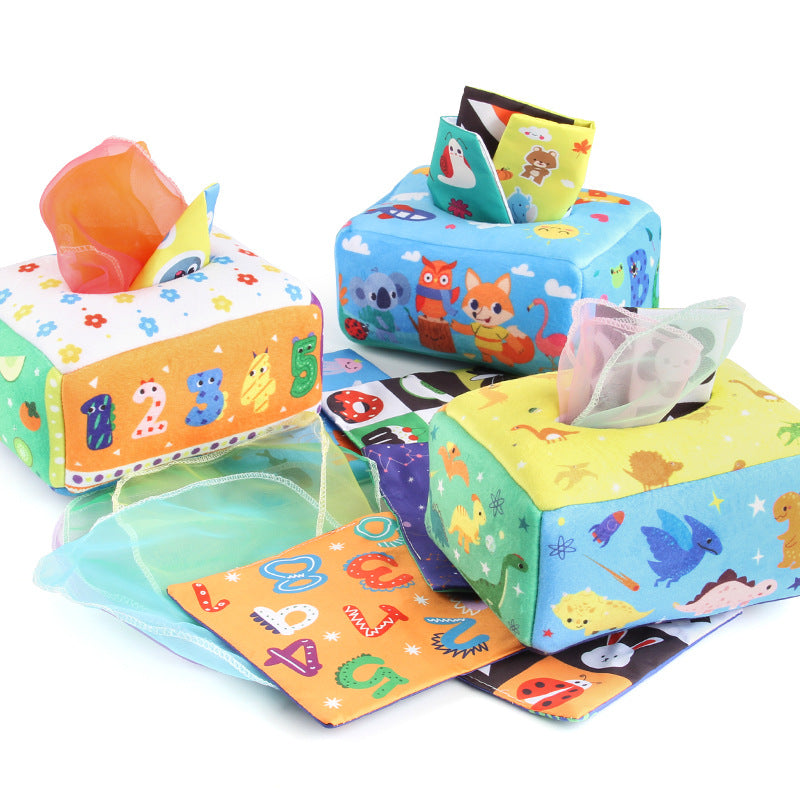 Baby playing with a Montessori-inspired sensory tissue box toy, developing fine motor skills and visual focus
