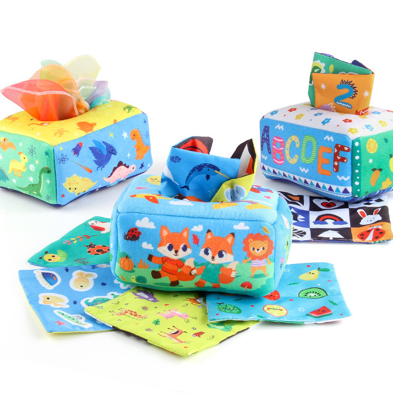 Baby playing with a Montessori-inspired sensory tissue box toy, developing fine motor skills and visual focus