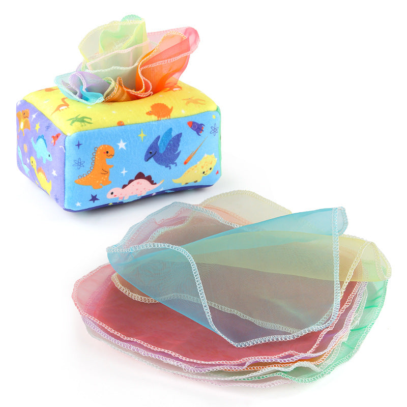 Baby playing with a Montessori-inspired sensory tissue box toy, developing fine motor skills and visual focus
