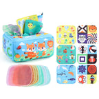 Baby playing with a Montessori-inspired sensory tissue box toy, developing fine motor skills and visual focus