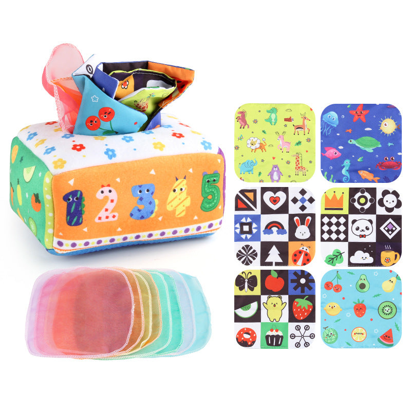Baby playing with a Montessori-inspired sensory tissue box toy, developing fine motor skills and visual focus
