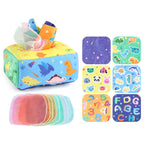 Baby playing with a Montessori-inspired sensory tissue box toy, developing fine motor skills and visual focus