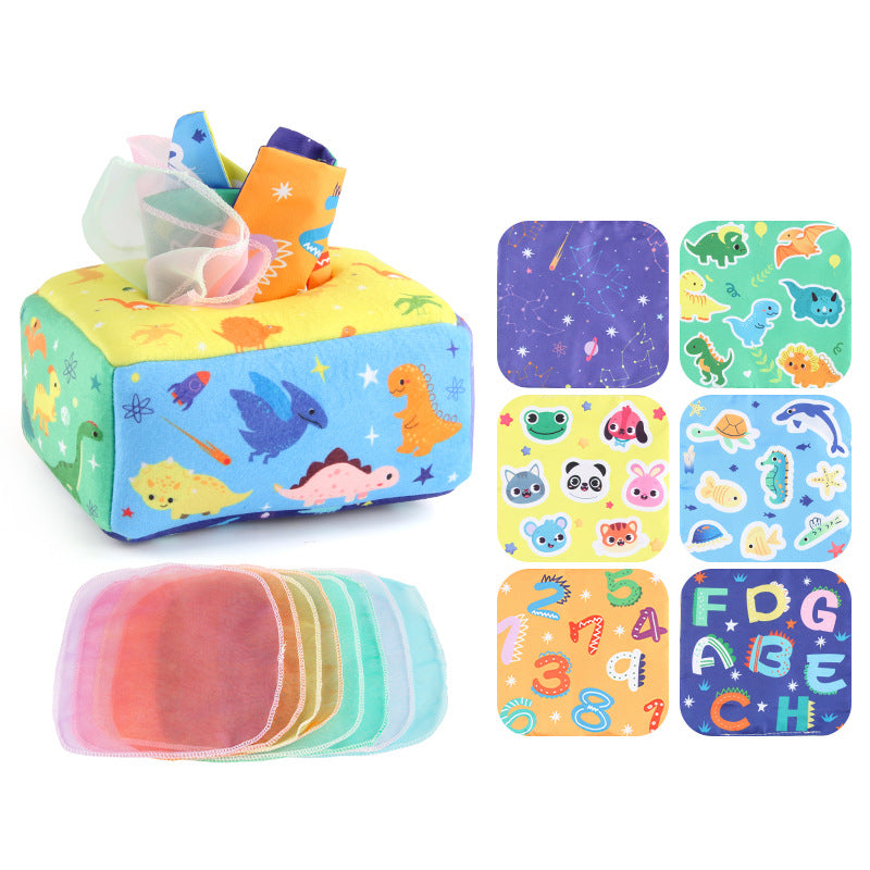 Baby playing with a Montessori-inspired sensory tissue box toy, developing fine motor skills and visual focus