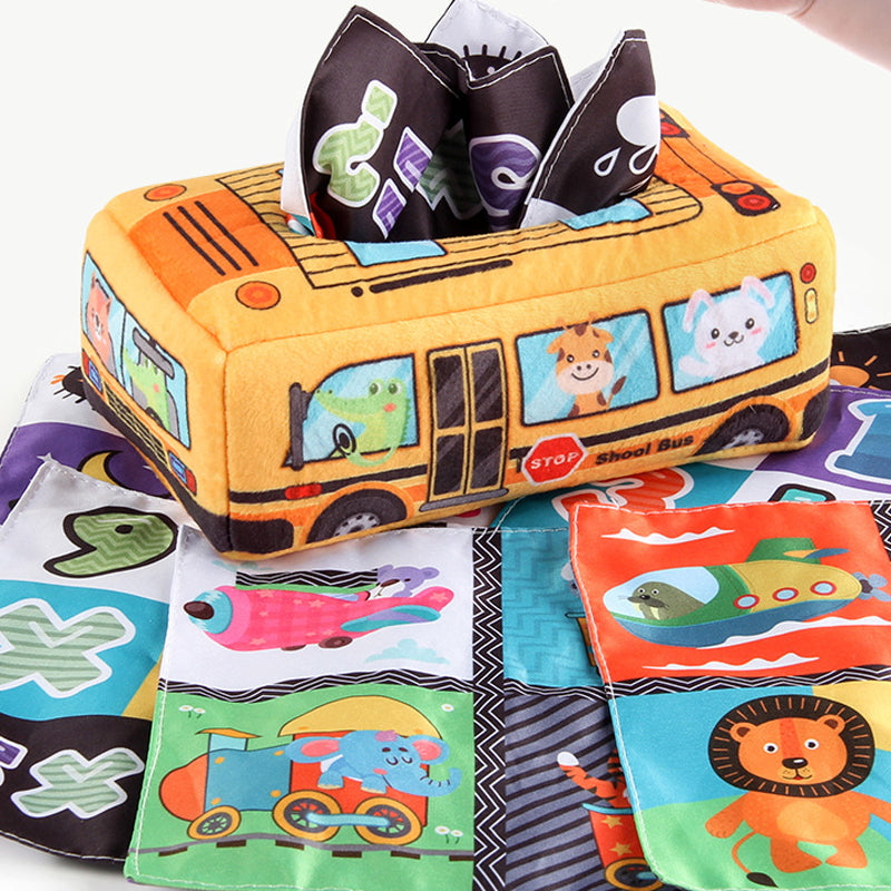Baby playing with a Montessori sensory toy featuring crinkle sound tissues to develop hand-eye coordination and fine motor skills