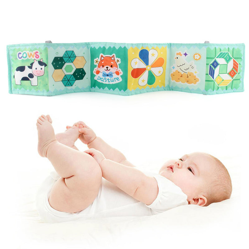 Montessori soft-color contrast cloth book for newborns, hanging on crib with gentle animal patterns (elephant, bear) to safely develop visual tracking skills