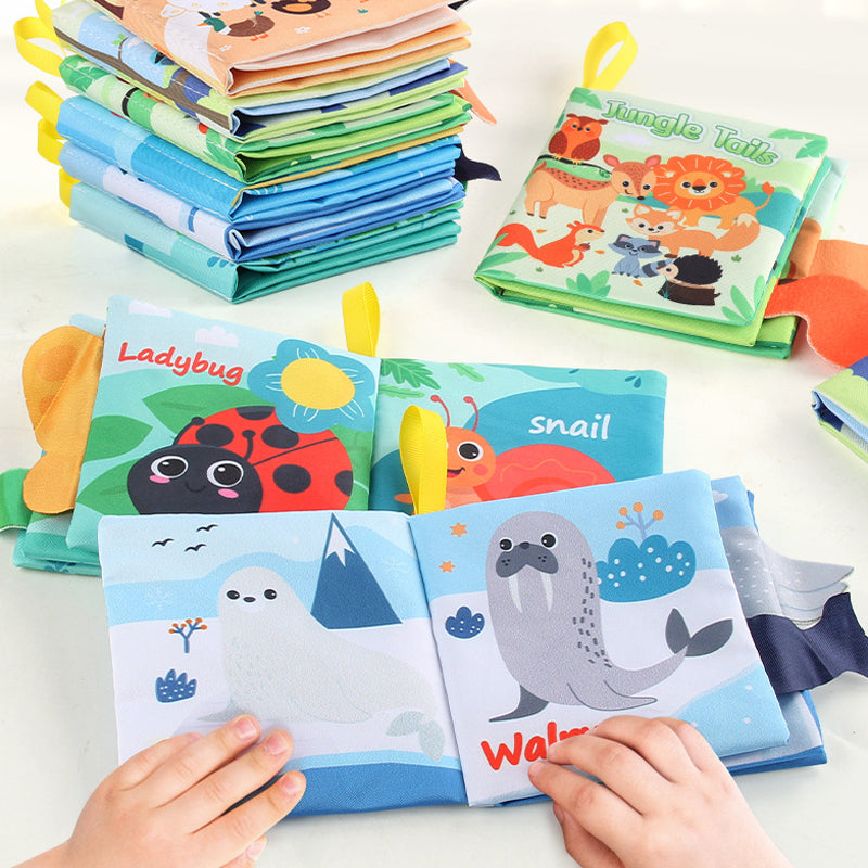 Baby touching crinkle fabric page in Busy Book. 3D textured whale tail (tactile), mirror element (visual), and sound paper (auditory) for multisensory learning 0-3 years.