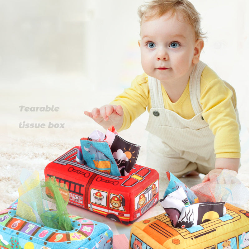 Baby playing with a Montessori-inspired tissue pull toy, designed for mess-free fun and early learning