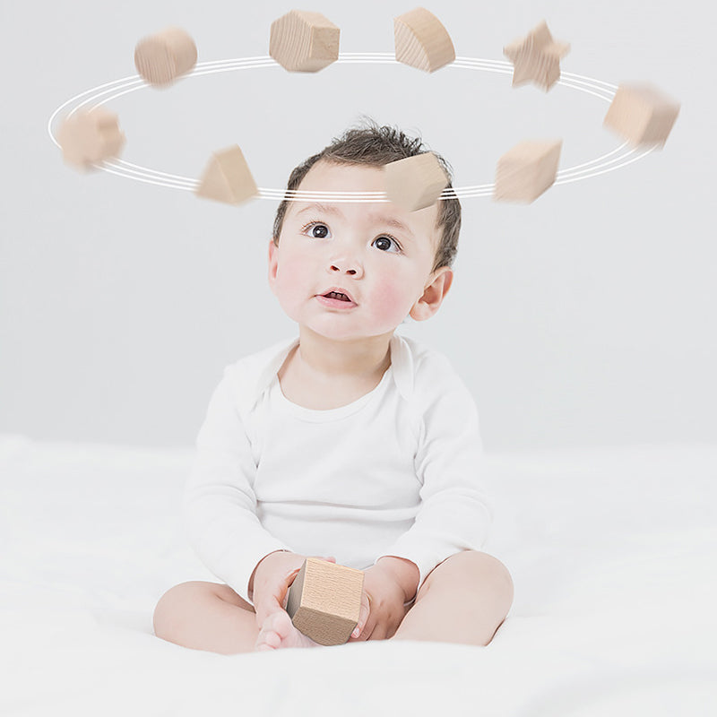 18-month-old child safely touching unfinished beechwood shape sorter with smooth edges, experiencing natural sensory play